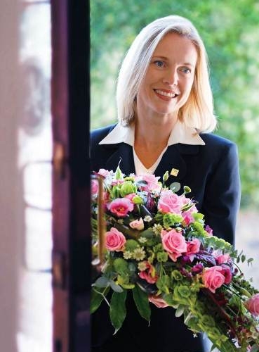 Lady Funeral Director With Flowers